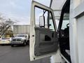 A 2007 International 4200 truck with its driver's side door open showing the interior features and dashboard