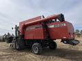 A red 1997 Massey Ferguson 8680 combine harvester with large wheels and a prominent unloading auger on the side