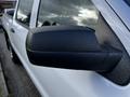 Close-up of the side mirror of a 2017 GMC Sierra 1500 showcasing a black casing with a textured finish