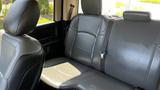 Interior view of the backseat of a 2019 RAM 3500 featuring black leather upholstery and a central seat console