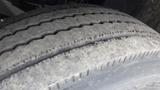 Close-up view of a worn tire on a 2012 International TerraStar showcasing tread wear and surface texture