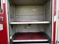 Interior of a 1994 Freightliner FL80 showing empty shelving without any equipment visible