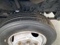 A close-up of a tire on a 2005 Freightliner MT45 Chassis showing tread wear and dirt on the side of the tire