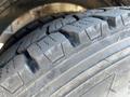 Close-up of a tire from a 2010 Freightliner MT45 garbage truck showing tread pattern and rubber surface details