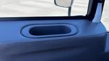 Close-up of the interior door panel of a 2019 International 4300 featuring a circular cup holder indentation