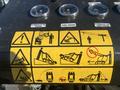 A control panel displaying various warning icons and gauges including hydraulic oil and fuel levels with instructions for the operation of a 2024 AGT KTT23