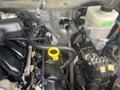 Close-up view of a 2017 Ford F-550 engine components including two hoses and a yellow dipstick located near the engine block and fluid reservoir