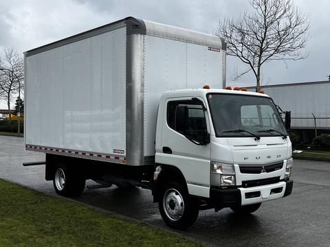 A white 2021 Mitsubishi FE box truck with a silver cargo area and orange marker lights on the roof