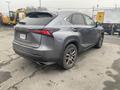 A gray 2021 Lexus NX 300 parked with a visible rear view showcasing its sleek design and distinctive taillights