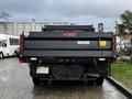 A black 2021 Ford F-550 truck is seen from the rear showcasing its tailgate with a Voith logo and license plate area along with rear lights and chains