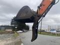 A 2006 Hitachi ZX200LC excavator with a large bucket attachment raised up ready for use