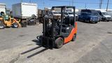 A 2018 Toyota 8FGCU25 forklift with an orange and gray exterior and black forks positioned for lifting