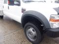 A white 2009 Ford F-450 SD with a prominent front wheel and tire showcasing its sturdy build and design details