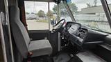 Interior of a 2006 Ford Econoline showing a driver's seat and dashboard with various controls and gauges