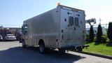 A silver 2005 Morgan Olson Workhorse delivery truck with a flat rear, side doors, and a roof-mounted light bar