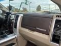 Interior dashboard of a 2010 Dodge Ram featuring wood and silver accents along with controls on the center console