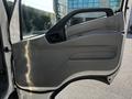 The image shows the driver's side door of a 2020 Hino 195 featuring a gray interior panel with a handle and controls for windows and locks