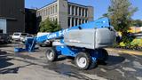 A blue 2008 Genie S-65 boom lift with large wheels and an elevated platform for reaching heights