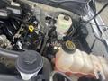 View of the engine compartment of a 2017 Ford F-550 with various components such as the coolant reservoir and brake fluid reservoir visible