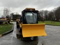 A 2015 International 3000 MT6 equipped with a large yellow snow plow attached to its front