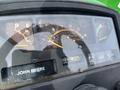 Close-up of the dashboard display of a John Deere 790 tractor showing gauges for engine temperature fuel level and operating hours