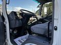 Interior of a 2020 Isuzu NPR showing the driver's seat steering wheel and dashboard with controls and pedals visible