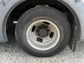 A close-up of a wheel and tire from a 2015 Chevrolet Express showing the rim and tire tread details