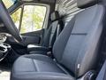 Front seats of a 2022 Mercedes-Benz Sprinter with a modern design featuring black upholstery and a simple dashboard layout