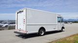 A white 2011 Ford Econoline delivery van seen from the rear with a boxy shape and large cargo area