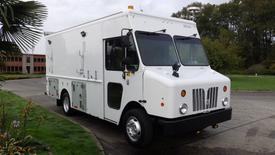 A white 2009 Morgan Olson Workhorse delivery truck featuring a boxy design with multiple side compartments and large front windows