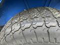 Close-up of a worn tire with deep treads typical for agricultural use likely from a 2007 New Holland TN70A tractor