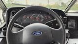 Dashboard of a 2006 Ford Econoline showing the steering wheel speedometer and various controls