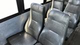 Interior seating of a 2014 Freightliner Thomas Bus Diesel with gray vinyl upholstery and a modern design