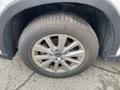 Close-up of a silver alloy wheel and tire of a 2016 Mazda CX-5 showing detailed spoke design and tread pattern