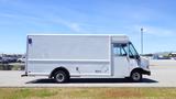 A white 2006 Ford Econoline cargo van with a boxy shape and a single sliding side door