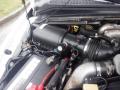 Close-up of the engine compartment of a 2009 Ford F-450 SD featuring the air intake system and battery connections