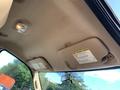 Interior view of a 2013 Ford F-450 SD showcasing the ceiling and visor with overhead light and warning labels