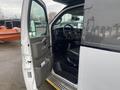 A 2017 Chevrolet Express van with its driver's side door open revealing the interior features and dashboard