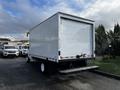 A white 2021 Ford Econoline cargo van with a closed rear door and a step bumper at the back