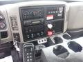 Dashboard of a 2009 International 7400 featuring various control switches gauges and a stereo system