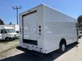 A white 2012 Ford Econoline van with a boxy shape and a large rear cargo door facing the viewer