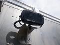 A mounted Trilliant LED work light attached to a metal surface with a flexible cord and switch