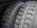 Close-up of two large, rugged tires designed for a 2008 International 7400 truck showing deep treads and sturdy construction