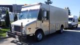 A 2005 Morgan Olson Workhorse delivery truck with a silver exterior and multiple side compartments for storage