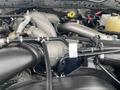 Close-up view of the engine components of a 2021 Ford F-550 including the turbocharger intake and various hoses