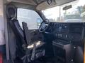 Interior view of a 2017 Chevrolet Express with a driver's seat and dashboard featuring various controls and instrumentation