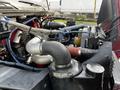 A close-up view of the engine of a 1994 Freightliner FL80 featuring various hoses and components including a large turbocharger and an air intake system