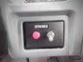 A control panel with a black switch labeled "STROBES" and a pink button located on a dashboard