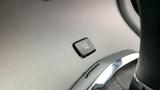 Close-up of a button in a 2013 Lincoln MKT vehicle interior used to open the trunk or rear hatch