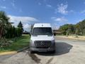 White 2021 Mercedes-Benz Sprinter van facing forward with a recognizable logo on the front grille